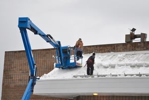 workers in bucket snow on roof fall protection